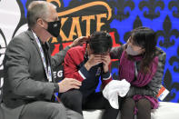 Vincent Zhou, center, reacts after receiving his final scores in the mens free skate at the Skate American figure skaint event Saturday, Oct. 23, 2021, in Las Vegas. (AP Photo/David Becker)