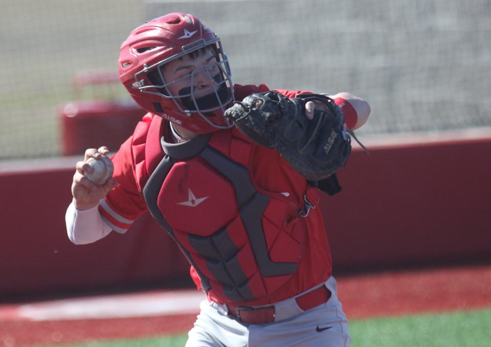 Shelby catcher Tanner Hartz finds using the electronic communication device much easier than the old ways of calling pitches.