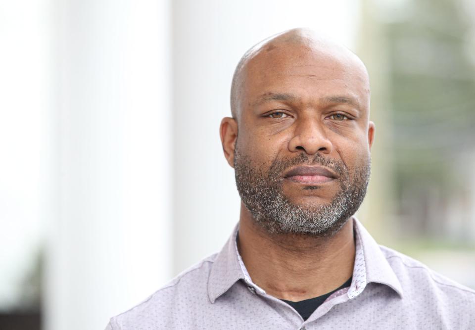 Jarvis Binford, a Norton Healthcare employee suing the company in a racial discrimination lawsuit, stands for a portrait in March 2024 at the Bahe, Cook, Cantley & Nefzger law office.