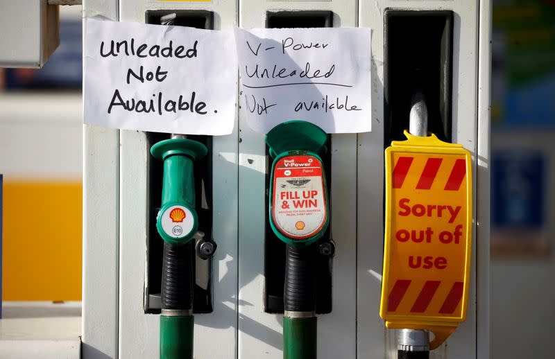 FILE PHOTO: Hand written signs are stuck to a petrol pump with no fuel available at a Shell filling station in Manchester