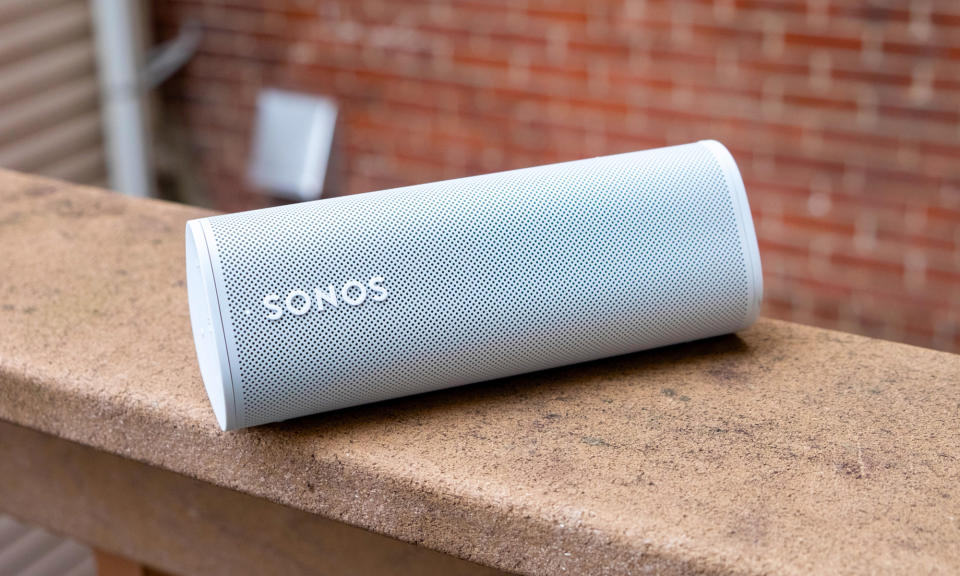 A white Sonos Roam speaker sitting on an outdoor ledge.