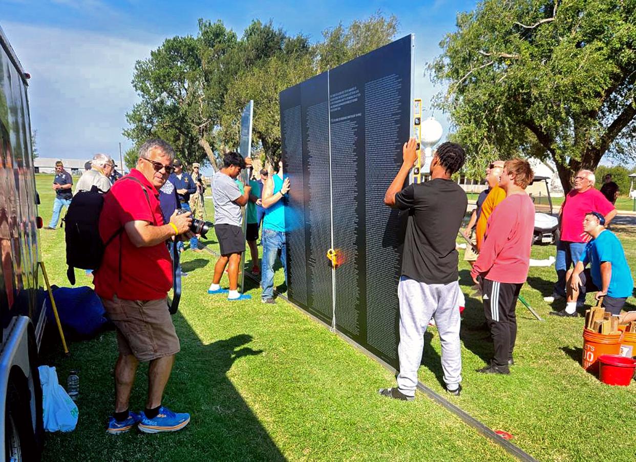 Volunteers help assemble an 80% scale replica of the Vietnam Memorial Wall at Fort Reno in El Reno, Oklahoma. The wall will be on display Sept. 28, 29 and 30.
