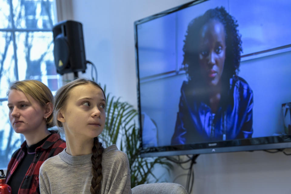Climate activist Vanessa Nakate, right, speaks via video-link as Ell Ottosson Jarl and Greta Thunberg, center, also attend a press conference with climate activists and experts from Africa in Stockholm, Sweden, Friday Jan. 31, 2020. Ugandan climate activist Vanessa Nakate and peers from other African nations on Friday made an urgent appeal for the world to pay more attention to the continent that stands to suffer the most from global warming despite contributing to it the least. (Pontus Lundahl/TT via AP)