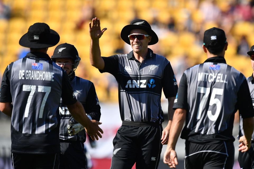 New Zealand's captain Tim Southee (C) celebrates with Colin de Grandhomme (L) after taking the wicket of England's Sam Billings during the Twenty20 cricket match between New Zealand and England at Westpac Stadium in Wellington on November 3, 2019. (Photo by Marty MELVILLE / AFP) (Photo by MARTY MELVILLE/AFP /AFP via Getty Images)