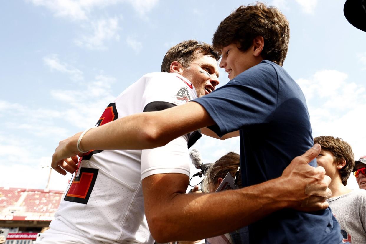 Tom Brady #12 of the Tampa Bay Buccaneers hugs his son John Edward Thomas Moynahan on the sidelines prior to the game against the Green Bay Packers