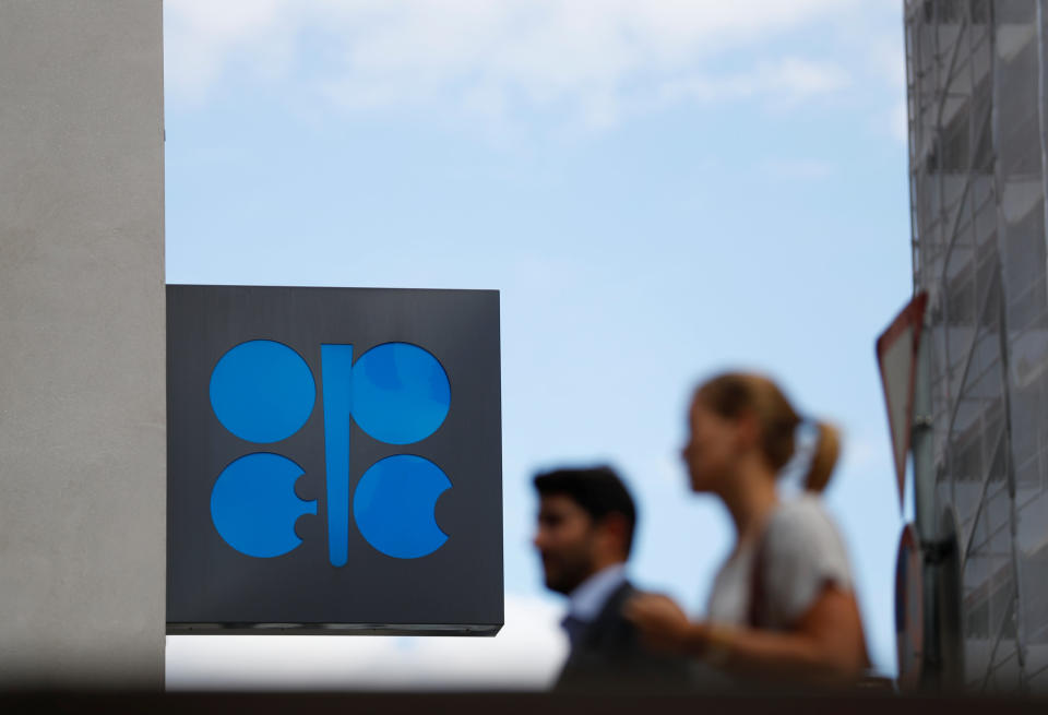 Two persons pass the logo of the Organization of the Petroleoum Exporting Countries (OPEC) in front of OPEC’s headquarters in Vienna, Austria June 19, 2018. REUTERS/Leonhard Foeger