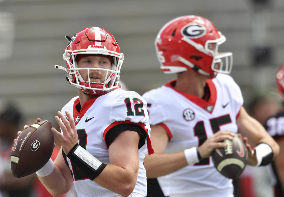 FILE - Georgia's quarterbacks Brock Vandagriff (12) and Carson Beck (15) warm up before the G - Day football game at Sanford Stadium, Saturday, April 15, 2023, in Athens, Ga. Georgia opens their season at home against Tennessee-Martin on Sept. 2. (Hyosub Shin/Atlanta Journal-Constitution via AP, File)