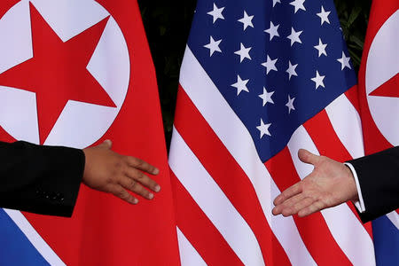 FILE PHOTO: U.S. President Donald Trump and North Korea's leader Kim Jong Un meet at the start of their summit at the Capella Hotel on the resort island of Sentosa, Singapore June 12, 2018. Picture taken June 12, 2018. REUTERS/Jonathan Ernst/File Photo