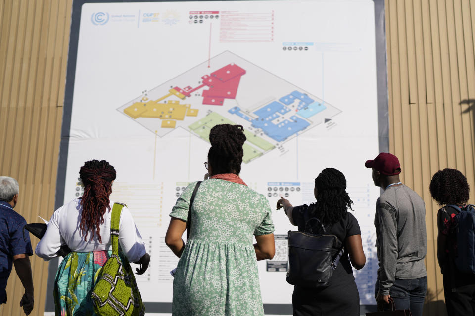 People look at a map while arriving for the COP27 U.N. Climate Summit, Sunday, Nov. 6, 2022, in Sharm el-Sheikh, Egypt. (AP Photo/Peter Dejong)