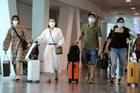 Passengers wearing masks are seen at Kuala Lumpur International Airport 2 in Sepang