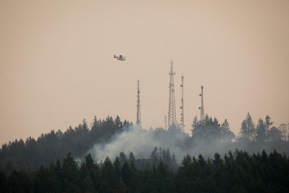 Planes drop water from the Willamette River on the Vitae Springs fire on Saturday, Sept. 10, 2022 in Salem, Ore. The fire is now 100 percent contained. 