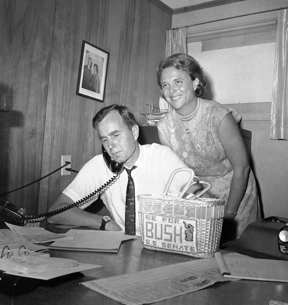 In this June 6, 1964, file photo George H.W. Bush, candidate for the Republican nomination for the U.S. Senate, gets returns by phone at his headquarters in Houston, as his wife Barbara, smiles at the news. Bush died at the age of 94 on Friday, Nov. 30, 2018, about eight months after the death of his wife, Barbara Bush. (AP Photo/Ed Kolenovsky, File) (Photo: ASSOCIATED PRESS)