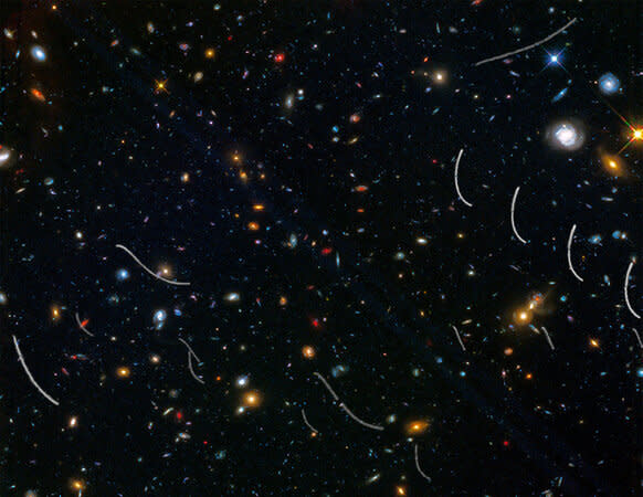 A Hubble observation of the galaxy cluster Abell 370 was littered with asteroids moving through the image, leaving behind curved streaks.