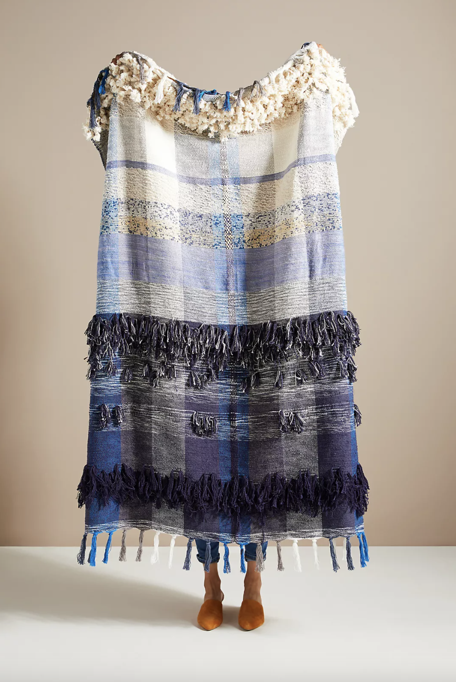 All Roads Bloomfield Throw Blanket in white blue grey and fringe (Photo via Anthropologie)