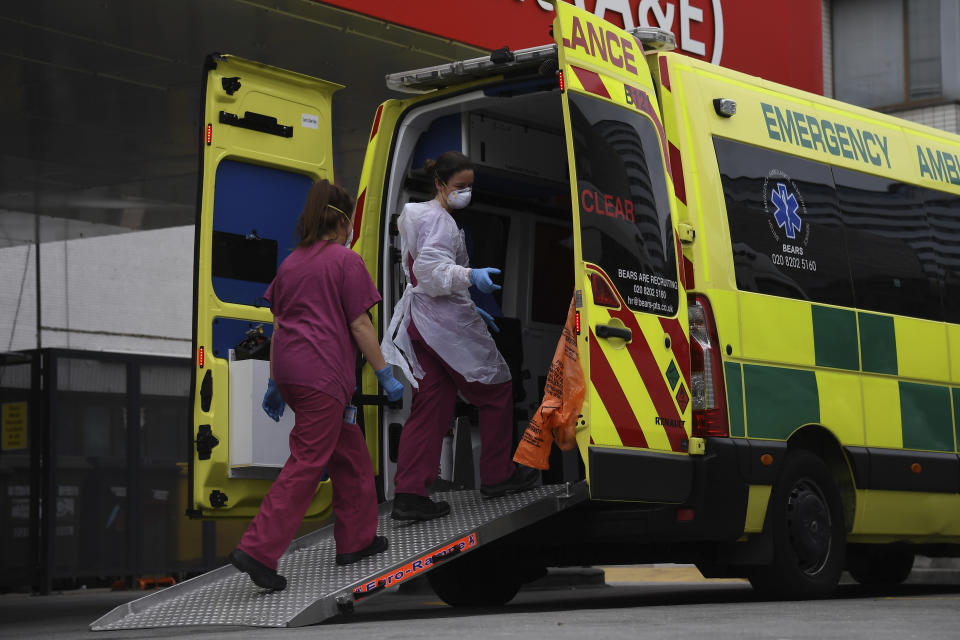 Medical workers clean an ambulance at St Thomas' Hospital, one of the many hospitals dealing with Coronavirus patients in London, Wednesday, April 1, 2020. The new coronavirus causes mild or moderate symptoms for most people, but for some, especially older adults and people with existing health problems, it can cause more severe illness or death.(AP Photo/Alberto Pezzali)