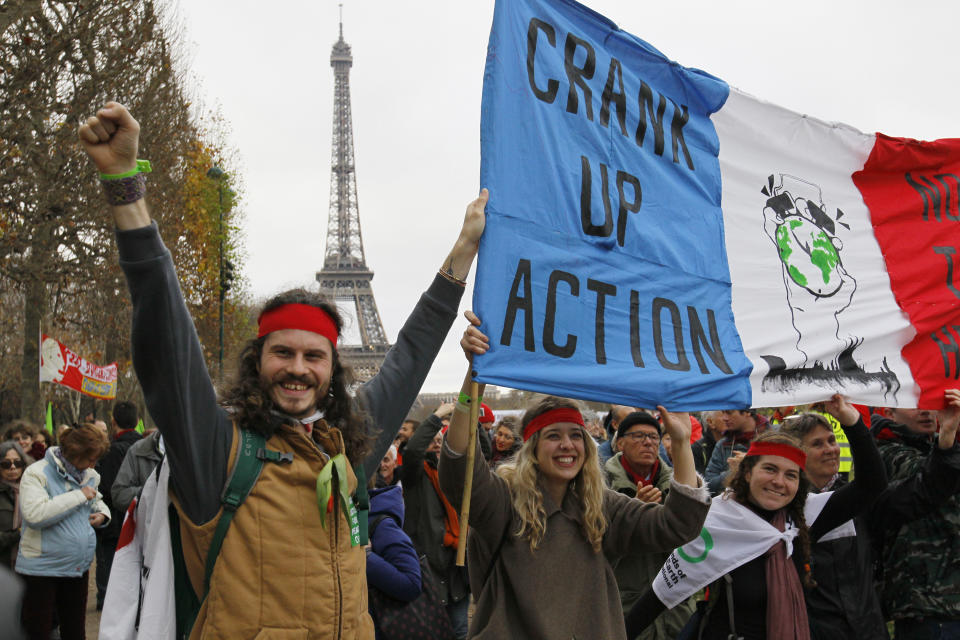 Environmentalists hold a banner 