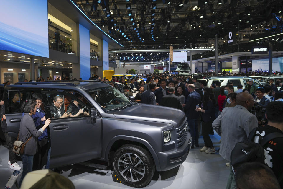 Visitors look at a Great Wall's Haval car during the opening of China Auto Show in Beijing, China, Thursday, April 25, 2024. (AP Photo/Tatan Syuflana)