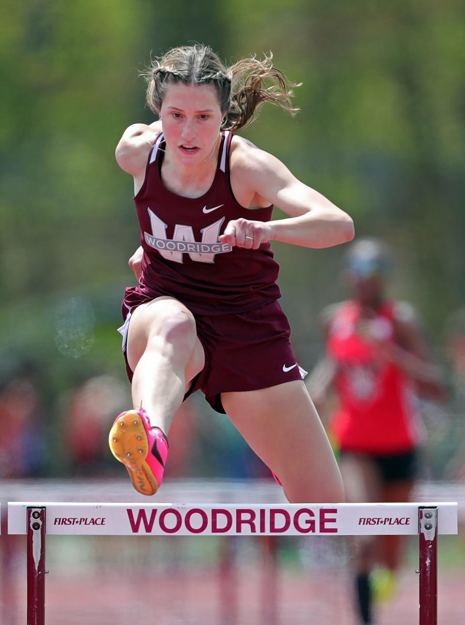 Anna Rorrer of Woodridge clears the final hurdle en route to a first-place finish in the girls 300-meter hurdles at the Woodridge Wrap-Up track meet on May 6 in Cuyahoga Falls.