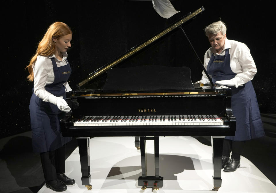 Freddie Mercury's Yamaha Grand Piano, estimated at 2-3 million pounds, on display at Sotheby's auction rooms in London, Thursday, Aug. 3, 2023. More than 1,000 of Freddie Mercury's personal items, including his flamboyant stage costumes, handwritten drafts of “Bohemian Rhapsody” and the baby grand piano he used to compose Queen's greatest hits, are going on show in an exhibition at Sotheby's London ahead of their sale. (AP Photo/Kirsty Wigglesworth)