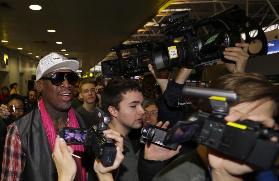 Former NBA basketball player Dennis Rodman talks to journalists as he arrives at the Beijing Capital International Airport to leave for Pyongyang, in Beijing