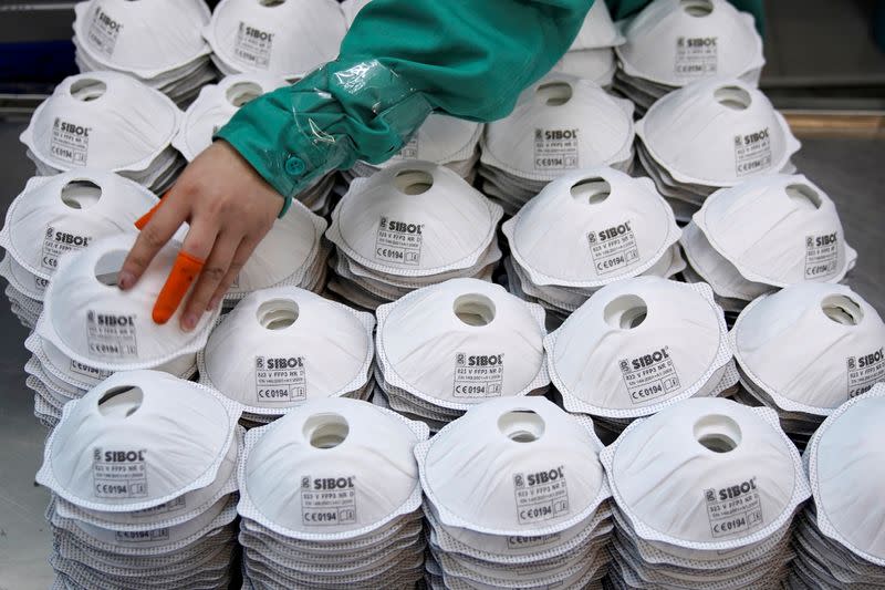 FILE PHOTO: FILE PHOTO: Masks are seen on a production line manufacturing masks at a factory in Shanghai