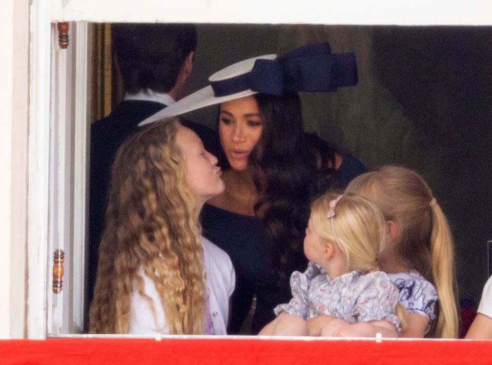 Meghan Markle with Savannah Phillips and Mia Tindall in the  Major General's office overlooking The Trooping of the Colour on Horse Guards Parade.