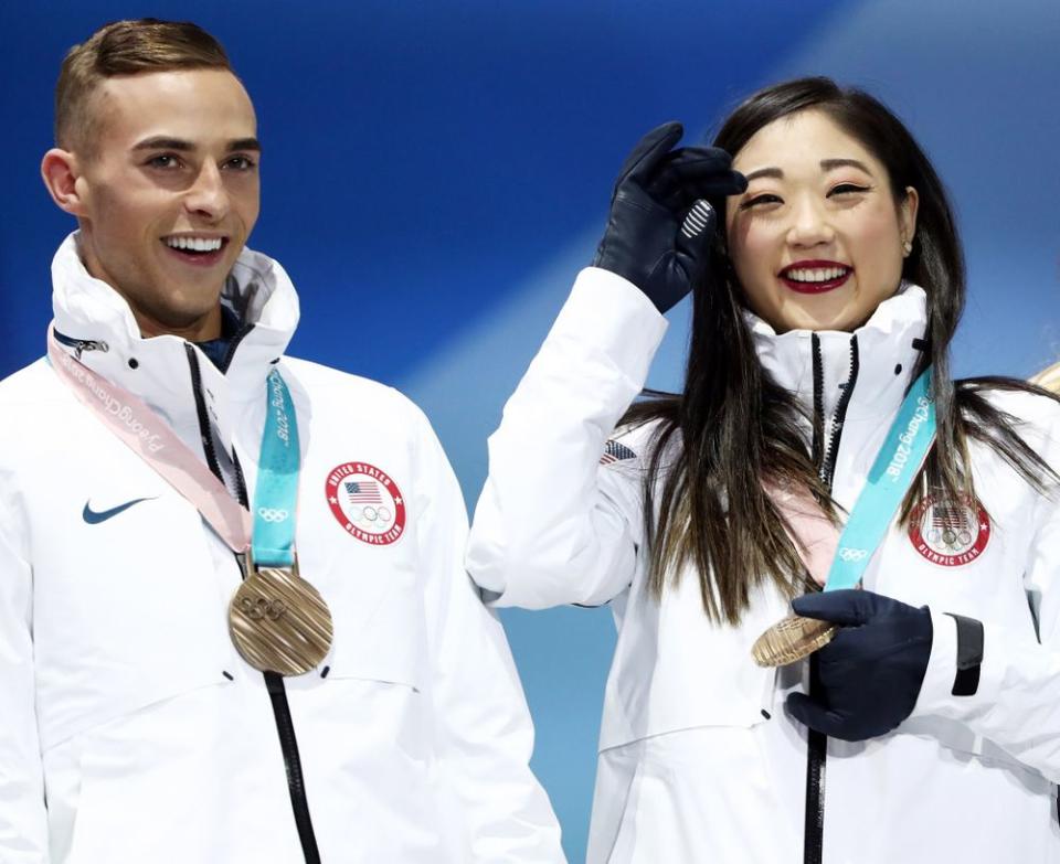 From left: U.S. figure skaters Adam Rippon and Mirai Nagasu with the bronze medals they and other American figure skaters won in the team event at the 2018 Winter Olympics