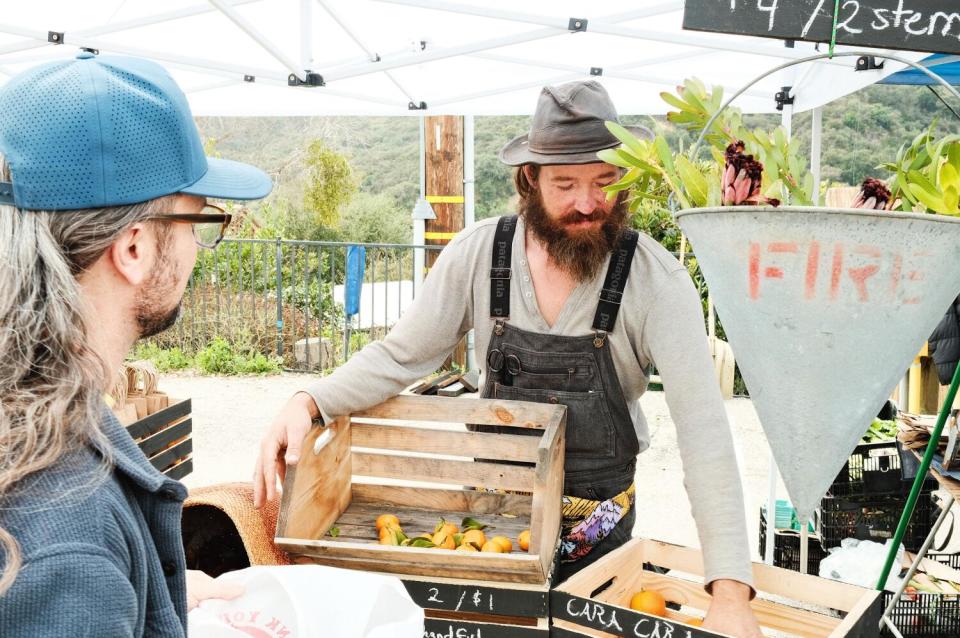 Farmer Mark Welborn of Aquifer Gardens mans his booth at the Topanga Farmers Market.