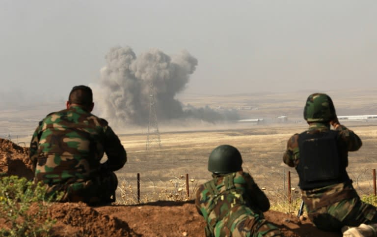 Smoke billows on the front line as Iraqi Kurdish Peshmerga fighters hold a position near Hasan Sham village, some 45 kilometres east of the city of Mosul, during an operation aimed at retaking areas from the Islamic State group on May 29, 2016