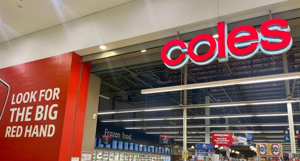 Coles store front with frozen food section visible inside.
