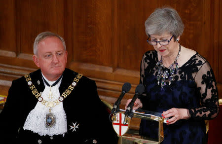 Lord Mayor of London Peter Estlin's listens as Britain's Prime Minister Theresa May delivers a speech during the annual Lord Mayor's Banquet at Guildhall in London, Britain, November 12, 2018. REUTERS/Henry Nicholls