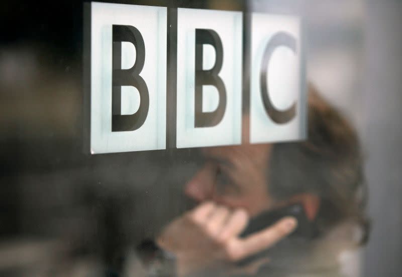 A man talks on a mobile phone inside the BBC headquarters in London