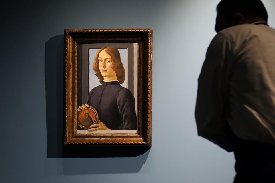 FILE — In this Sept. 23, 2020, file photo, Sandro Botticelli's 15th-century painting called "Young Man Holding a Roundel" is displayed at Sotheby's, in New York. The small painting sold at Sotheby's in New York on Thursday, Jan, 28, 2021, for $92.2 million, an auction record for the Renaissance master. (AP Photo/Seth Wenig, File)