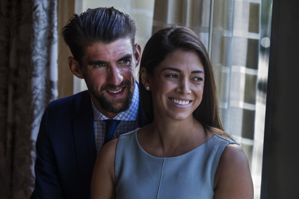BOSTON, MA - MAY 21: Michael Phelps, the most decorated Olympian of all time, stands with his wife Nicole Johnson before receiving the Morton E. Ruderman Award in Inclusion at the Four Seasons Hotel in Boston on May 21, 2019. (Photo by Stan Grossfeld/The Boston Globe via Getty Images)