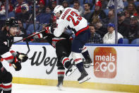 Washington Capitals center Michael Sgarbossa (23) collides with Buffalo Sabres defenseman Henri Jokiharju (10) during the second period of an NHL hockey game Tuesday, April 2, 2024, in Buffalo, N.Y. (AP Photo/Jeffrey T. Barnes)