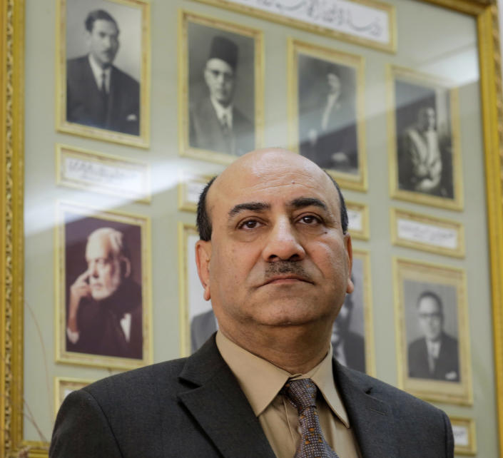 In this Tuesday, April 16, 2014 photo, Hesham Genena, the head of Egypt's oversight body, poses for a portrait in front of pictures of his predecessors at his office in Cairo, Egypt. Genena has created uproar simply because he decided to actually do his job. The head of one of Egypt’s foremost government oversight agencies, he says he has uncovered billions of dollars-worth of corruption, including in the country’s most untouchable institutions, including the police, intelligence agencies, and the judiciary.(AP Photo/Amr Nabil)