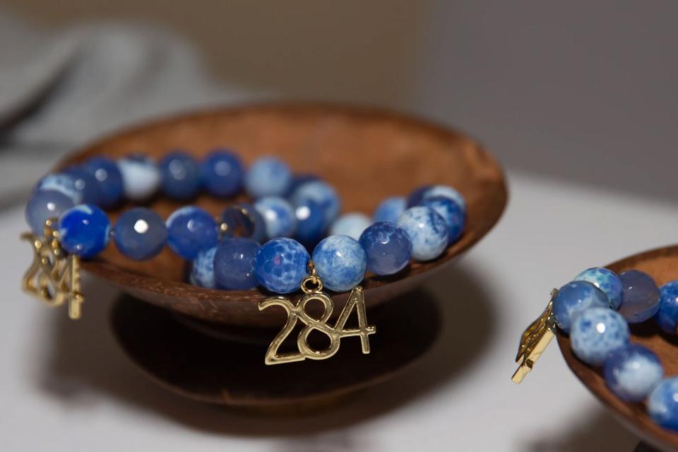 Blue beaded bracelet with gold charm