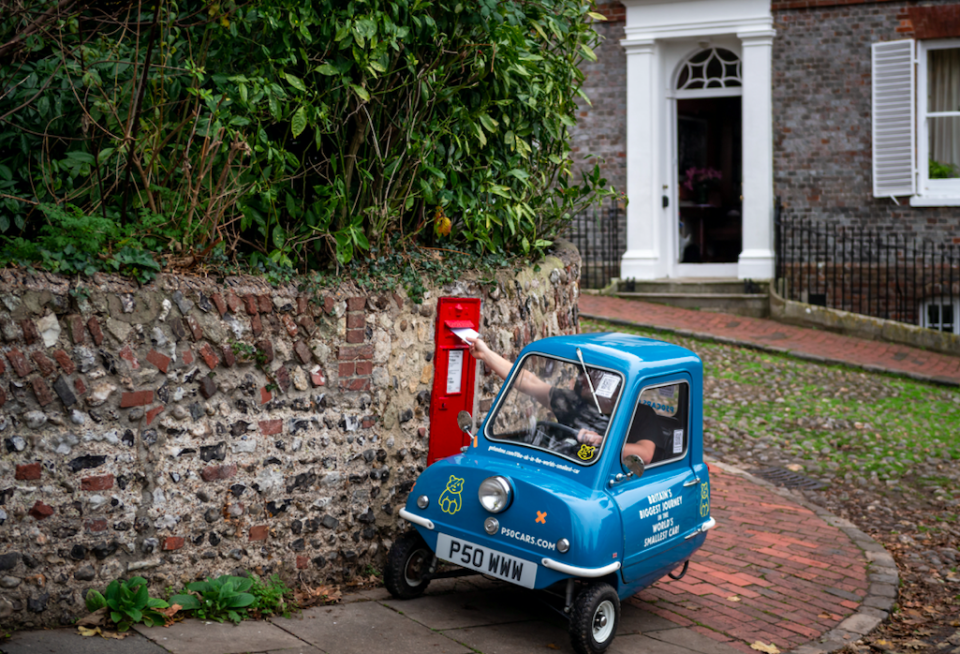 Alex Orchin carries out chores in the Peel P50 near his home in Wivelsfield, Sussex. (SWNS)