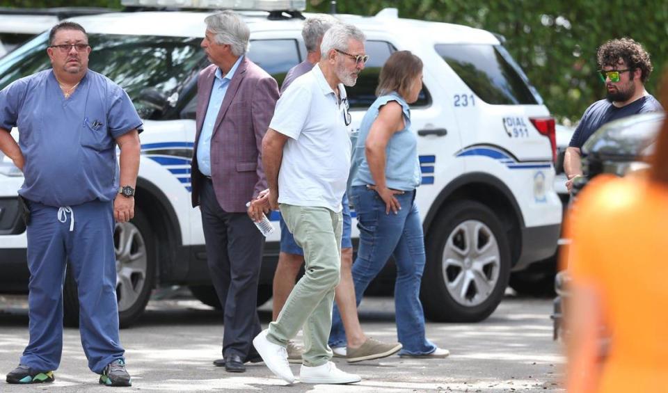 As the FBI and police work the scene, Sergio Pino’s defense attorney, Sam Rabin, at center, is seen on the street near Pino’s home in Coral Gables, Florida, on Tuesday, July 16, 2024.