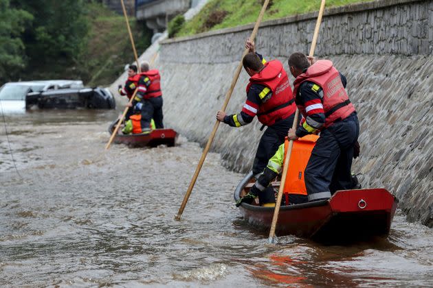 Austrian firefighters steer a boat in a flooded street in Pepinster on July 16, 2021, where the situation remains critical after the heavy rainfall of the previous days. - The death toll from devastating floods in Europe soared to at least 126 on July 16, 2021, most in western Germany where emergency responders were frantically searching for missing people. In Belgium, the government confirmed the death toll had jumped to 20 -- earlier reports had said 23 dead -- with more than 21,000 people left without electricity in one region. (Photo by François WALSCHAERTS / AFP) (Photo by FRANCOIS WALSCHAERTS/AFP via Getty Images) (Photo: FRANCOIS WALSCHAERTS via Getty Images)