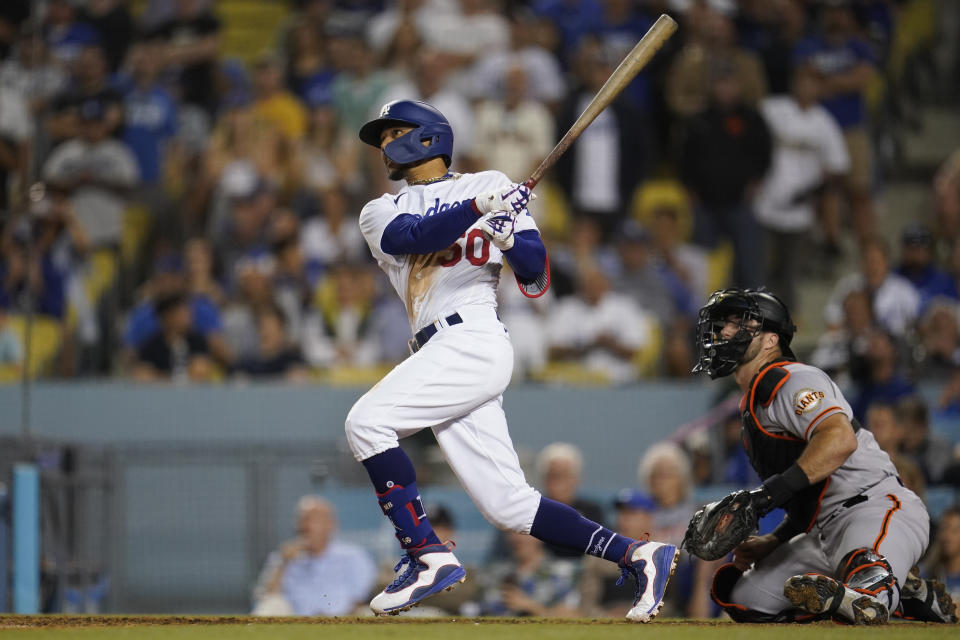 Los Angeles Dodgers' Mookie Betts watches his three-run home run during the eighth inning of the team's baseball game against the San Francisco Giants on Thursday, July 21, 2022, in Los Angeles. (AP Photo/Marcio Jose Sanchez)