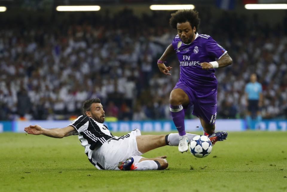 <p>Real Madrid’s Marcelo in action with Juventus’ Andrea Barzagli </p>