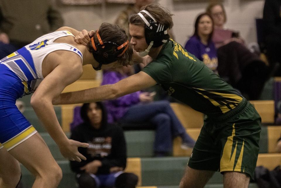 Justin Crozier of Ida (left) and Blake Gust of St. Mary Catholic Central fight for hand control during the SMCC Falcon Duals Saturday.