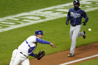 Kansas City Royals catcher Salvador Perez, left, throws to first for a double play hit into by Tampa Bay Rays' Francisco Mejia after forcing out Randy Arozarena, right, out at home during the sixth inning of a baseball game Monday, April 19, 2021, in Kansas City, Mo. (AP Photo/Charlie Riedel)