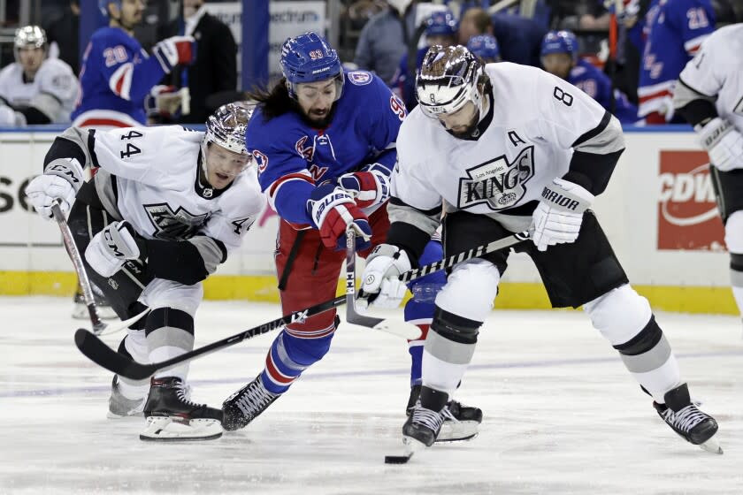 Los Angeles Kings defenseman Drew Doughty (8) takes the puck fron New York Rangers center Mika Zibanejad.