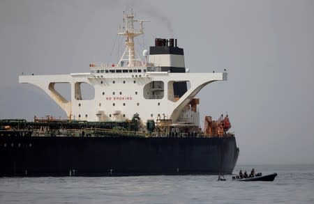 FILE PHOTO: Gibraltar defence police officers guard the Iranian oil tanker Grace 1 as it sits anchored after it was seized earlier this month by British Royal Marines in the Strait of Gibraltar