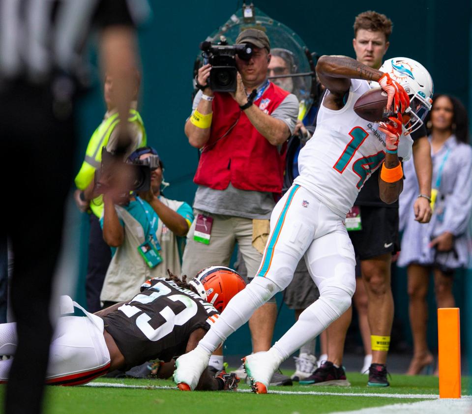 Miami Dolphins wide receiver Trent Sherfield (14), scores a touchdown in front of Cleveland Browns cornerback Martin Emerson Jr. (23), late in the second quarter of their NFL action Sunday November 13, 2022 at Hard Rock Stadium in Miami Gardens.