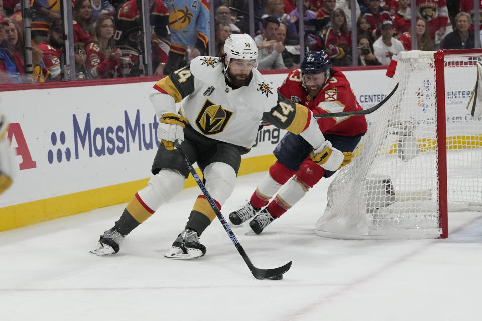 Vegas Golden Knights defenseman Nicolas Hague (14) skates ahead of Florida Panthers center Carter Verhaeghe (23) during the second period of Game 3 of the NHL hockey Stanley Cup Finals, Thursday, June 8, 2023, in Sunrise, Fla. (AP Photo/Lynne Sladky)