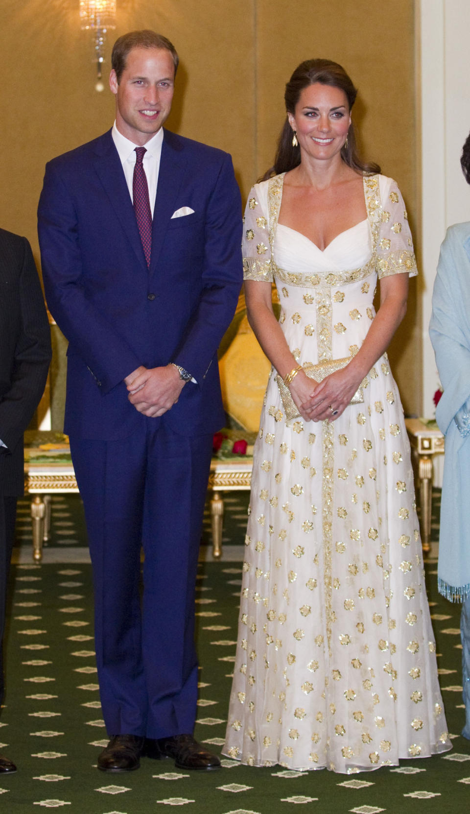 <p>The Duchess attended a dinner with the King of Malaysia wearing a head-turning custom Alexander McQueen gown. Designed in a cream shade with gold embroidery, Kate carried a golden clutch by Wilbur and Gussie. </p><p><i>[Photo: PA]</i></p>