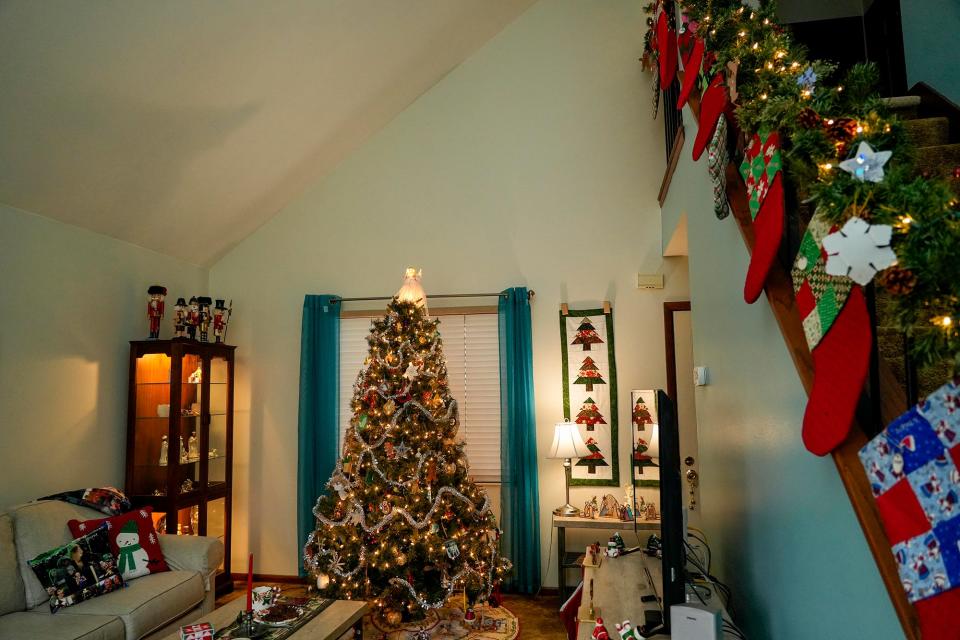 A Christmas tree and homemade stockings are shown at Diane Evans' home.